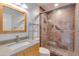 Updated bathroom with a glass enclosed shower, a light countertop vanity and a framed mirror at 5333 N Las Casitas Pl, Phoenix, AZ 85016