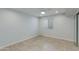 Minimalist bedroom with neutral tones, tile floor, and mirrored closet doors at 5333 N Las Casitas Pl, Phoenix, AZ 85016