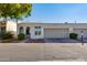 View of front exterior featuring an attached garage, covered entryway, and desert landscaping at 5333 N Las Casitas Pl, Phoenix, AZ 85016