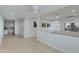 Open living room with bright white walls, tile floors, and split-level layout at 5333 N Las Casitas Pl, Phoenix, AZ 85016