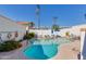 Community swimming pool features chairs, tables, and a blue umbrella at 5333 N Las Casitas Pl, Phoenix, AZ 85016