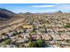 Wide aerial view of a neighborhood nestled in a desert landscape showcasing the nearby mountains at 5523 W Yearling Rd, Phoenix, AZ 85083