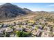 Aerial view of a community surrounded by desert mountains, highlighting the community pool at 5523 W Yearling Rd, Phoenix, AZ 85083
