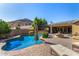 Beautiful backyard with a sparkling pool, tanning deck, and covered patio at 5523 W Yearling Rd, Phoenix, AZ 85083