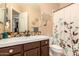 Traditional bathroom featuring brown cabinets, white countertop, and mosaic tile backsplash at 5523 W Yearling Rd, Phoenix, AZ 85083