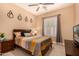 Cozy bedroom showcasing a ceiling fan, window shutters, and a comfortable queen-sized bed at 5523 W Yearling Rd, Phoenix, AZ 85083