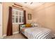Comfortable bedroom features neutral walls, shuttered windows, and a black metal bed frame at 5523 W Yearling Rd, Phoenix, AZ 85083