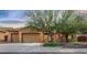 Charming home featuring a three car garage, desert landscaping, and a cozy front porch at 5523 W Yearling Rd, Phoenix, AZ 85083
