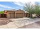 Charming home featuring a three car garage, desert landscaping, and a cozy front porch at 5523 W Yearling Rd, Phoenix, AZ 85083