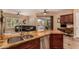 Granite countertop with sink overlooks the living room and outdoor living space at 5523 W Yearling Rd, Phoenix, AZ 85083
