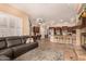 Inviting living room features a fireplace, gray sofa, and opens to kitchen with counter seating at 5523 W Yearling Rd, Phoenix, AZ 85083