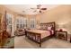 Well-lit main bedroom with a decorative bed frame and cozy seating area at 5523 W Yearling Rd, Phoenix, AZ 85083