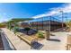 Shaded picnic area with tables, benches, and grill, adjacent to a tennis court, perfect for outdoor gatherings at 5523 W Yearling Rd, Phoenix, AZ 85083