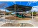 Well-equipped playground with shade covering, slides, and climbing structures, set in a secure area with gravel and walkways at 5523 W Yearling Rd, Phoenix, AZ 85083
