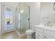 Modern bathroom featuring a glass-enclosed shower with pebble flooring and stone tile walls at 5892 E Evening Glow Dr, Scottsdale, AZ 85266