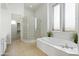 Bright bathroom features a soaking tub, glass shower, and neutral color scheme at 5892 E Evening Glow Dr, Scottsdale, AZ 85266