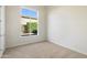Bright, empty bedroom with neutral carpet and a garden view at 5892 E Evening Glow Dr, Scottsdale, AZ 85266