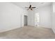 Spacious primary bedroom with neutral carpet, ceiling fan, and ensuite bathroom at 5892 E Evening Glow Dr, Scottsdale, AZ 85266