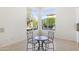 Bright breakfast nook featuring a round table, two chairs and large windows with a view to the property's garden at 5892 E Evening Glow Dr, Scottsdale, AZ 85266