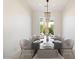 Modern dining room with a stylish chandelier, large window, and table set for eight guests at 5892 E Evening Glow Dr, Scottsdale, AZ 85266