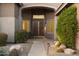 Inviting front entrance with a beautifully designed walkway and meticulously maintained desert landscaping at 5892 E Evening Glow Dr, Scottsdale, AZ 85266