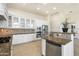 Well-lit kitchen with white cabinets, granite countertops, stainless steel appliances, and a breakfast bar at 5892 E Evening Glow Dr, Scottsdale, AZ 85266