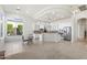 Open-concept living room flows to a kitchen with stainless steel appliances, a center island and bar seating at 5892 E Evening Glow Dr, Scottsdale, AZ 85266