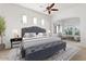A cozy bedroom with a large upholstered bed, a sitting area, and large rug at 5892 E Evening Glow Dr, Scottsdale, AZ 85266