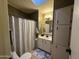 Bathroom featuring a single sink vanity with built-in linen closet and shower with curtain at 6161 S Pinehurst Dr, Chandler, AZ 85249