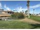 Picturesque community featuring a pond and views of palm trees under a blue sky at 6161 S Pinehurst Dr, Chandler, AZ 85249