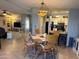 Cozy dining area features a round table, chairs with patterned cushions, and an eye-catching, geometric chandelier at 6161 S Pinehurst Dr, Chandler, AZ 85249