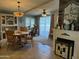 Bright dining room area with stylish lighting, a hutch and fireplace at 6161 S Pinehurst Dr, Chandler, AZ 85249