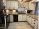 Efficient kitchen featuring white cabinets, black appliances, and ample countertop space at 6161 S Pinehurst Dr, Chandler, AZ 85249