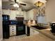 Well-lit kitchen with white cabinets, black appliances, and ample counter space at 6161 S Pinehurst Dr, Chandler, AZ 85249