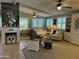 Spacious living room featuring a fireplace, large windows with shutters, and comfortable seating at 6161 S Pinehurst Dr, Chandler, AZ 85249