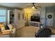 Inviting living room with a murphy bed, a TV set, comfortable seating, and bright lighting at 6161 S Pinehurst Dr, Chandler, AZ 85249