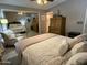 Spacious main bedroom features a mirrored closet, ceiling fan and a comfortable chair at 6161 S Pinehurst Dr, Chandler, AZ 85249