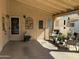 Inviting covered patio with comfortable seating, potted plants, and access doors at 6161 S Pinehurst Dr, Chandler, AZ 85249