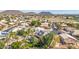 Aerial view of the home with a pool and mountain views in the distance at 6576 W Lone Cactus Dr, Glendale, AZ 85308