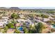 Aerial view of the home, showcasing its sparkling pool, landscaping, and neighborhood at 6576 W Lone Cactus Dr, Glendale, AZ 85308