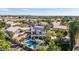 Stunning aerial view of backyard pool, lush landscaping, and solar panels on this beautiful home at 6576 W Lone Cactus Dr, Glendale, AZ 85308