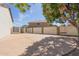 Large backyard concrete patio with a basketball hoop and a gated entrance at 6576 W Lone Cactus Dr, Glendale, AZ 85308