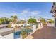 Balcony view of the backyard pool and neighborhood homes with solar panels and green landscaping at 6576 W Lone Cactus Dr, Glendale, AZ 85308