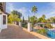 Balcony view overlooking the landscaped backyard, pool and an outdoor kitchen at 6576 W Lone Cactus Dr, Glendale, AZ 85308