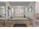 This bathroom features a soaking tub, decorative tile, and shuttered windows at 6576 W Lone Cactus Dr, Glendale, AZ 85308