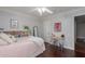 Airy bedroom featuring a cozy bed, a small bookcase, and a workspace with a desk and stool at 6576 W Lone Cactus Dr, Glendale, AZ 85308