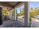 Covered patio with comfortable seating, ceiling fan, stone flooring and a view of the outdoor area at 6576 W Lone Cactus Dr, Glendale, AZ 85308