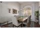Chandelier-lit dining area with a large window and seating for six at 6576 W Lone Cactus Dr, Glendale, AZ 85308