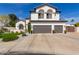Two-story home featuring a spacious three-car garage and landscaped front yard at 6576 W Lone Cactus Dr, Glendale, AZ 85308