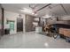 Spacious garage with epoxy flooring, storage cabinets and a door leading to the home's interior at 6576 W Lone Cactus Dr, Glendale, AZ 85308